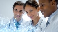 Diverse medical team analyzing digital health data visualization with glowing blue network effect, showcasing innovation in healthcare technology.