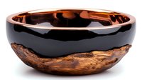 Handcrafted wooden bowl with black epoxy resin interior and copper-toned rim, featuring natural wood grain texture and organic shape for modern decor.