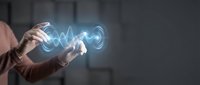 Businessman holding smartphone with glowing digital wave energy emanating from screen in modern office environment for technology presentations.