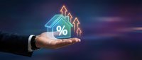 Businessman hand holding glowing house icon with percentage symbol and rising arrows showing real estate market growth and mortgage rates concept.