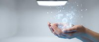 Hands holding glowing digital hologram with data network visualization and light particles, representing technology, innovation, and digital transformation for business solutions.