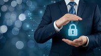 Professional businessman in dark suit protecting glowing digital padlock symbol with hands representing cybersecurity data protection and privacy concepts.