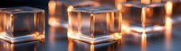 Transparent glass cubes with warm glowing light reflections creating elegant bokeh effect on blue surface.