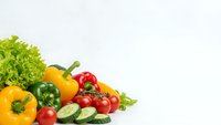 Fresh colorful vegetables including bell peppers, tomatoes, cucumbers and lettuce arranged on white background for healthy cooking and nutrition concepts.
