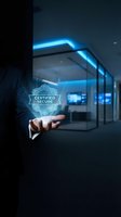 Businessman holding certified secure holographic badge in modern server room with glowing neon blue lights, representing cybersecurity and data protection technology.