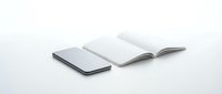 Smartphone and open blank notebook on white background, minimalist workspace concept for business, education, and productivity design.