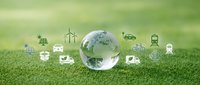 Crystal globe on green grass surrounded by renewable energy icons representing sustainable technology and environmental conservation solutions.