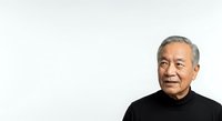 Senior Asian man with gray hair wearing black turtleneck against white background, suitable for corporate portraits, business profiles, and professional headshots.