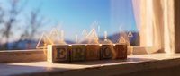 Wooden blocks spelling "BLOG" with glowing triangle icons floating above, representing digital content creation and online publishing strategy for websites and marketing campaigns.