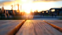 Wooden deck at sunset with blurred urban skyline background, warm golden light creating atmospheric outdoor space for relaxation.