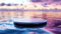 Circular platform floating on calm water surface with dreamy purple pink sunset sky reflection. Minimalist product display stage for cosmetics branding mockups.