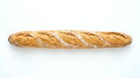 Freshly baked French baguette with crispy golden crust and diagonal scoring, isolated on white background for bakery, food, and culinary design use.