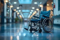 Empty wheelchair in hospital corridor with blue tinted lighting and bokeh effect. Medical facility hallway showing accessibility and healthcare concept.