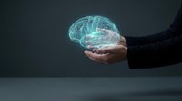 Businessman hand holding glowing digital brain hologram representing artificial intelligence, machine learning and cognitive technology innovation.