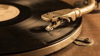Vintage turntable with tonearm and needle on vinyl record, retro music equipment for audio entertainment and nostalgic sound reproduction.