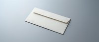 Cream colored envelope on gray background for business correspondence and mailing needs.