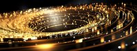 Abstract spiral pattern of golden lights and bokeh effects against dark background creates futuristic technological atmosphere for business and innovation concepts.