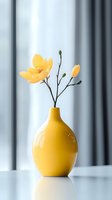 Yellow ceramic vase with delicate yellow flower blooms against soft white background, creating minimalist composition with gentle natural lighting and reflection.