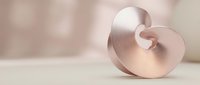 Elegant rose gold metallic spiral sculpture on neutral background for luxury design projects and modern interior decoration concepts.
