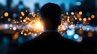 Silhouette of man against urban bokeh lights and bright sparks, creating dramatic contrast between dark figure and glowing city background at dusk.