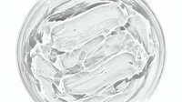 Clear gel or transparent cosmetic product swirled in glass container, showcasing texture and consistency for skincare, beauty, and cosmetics packaging design.