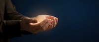 Open hands of an adult male with light skin tone in cupped gesture against dark blue background, conveying offering, receiving, care, support, spirituality, hope, charity, protection, and trust for business, healthcare, and motivational concepts.