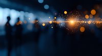 Blurred silhouette against dark blue background with glowing orange bokeh lights and lens flare creating magical atmosphere for business or spiritual concepts.