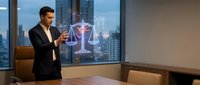 Professional businessman in dark suit using holographic justice scales technology in modern office conference room with city skyline view at dusk.