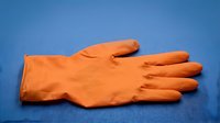 Orange rubber glove isolated on blue background, ready for design use on merchandise, promotional materials, cleaning service graphics, and household product packaging.