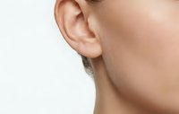 Close-up of human ear and neck profile showing detailed anatomy for medical education, healthcare concepts, and hearing-related content.