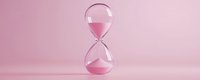 Glass hourglass with pink sand on soft pink background symbolizing time management, deadline pressure, and temporal concepts for business presentations.