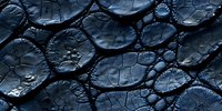 Dark blue cracked surface with hexagonal pattern and water drops creating dramatic texture and depth. Abstract background for modern design projects.