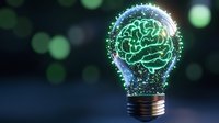 Glowing brain inside light bulb with sparkles and particles on dark background with bokeh effect. Creative thinking and innovation concept for business solutions.
