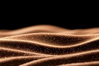 Glowing golden waves with sparkling particles on black background create mesmerizing abstract pattern. Luxury design element for festive backgrounds.