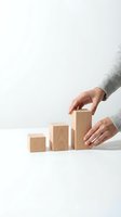 Hands arranging wooden blocks in ascending order showing business growth and development concept on white background for presentations.