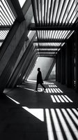 Silhouette of person walking through modern architectural corridor with geometric shadows cast by linear ceiling structure, contemporary interior design.