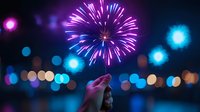 Silhouette of woman watching vibrant purple and blue fireworks display against night sky with blurred city lights creating magical bokeh effect in background.