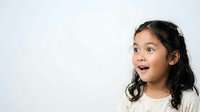 Young Asian girl with long dark hair and surprised expression, wearing light-colored shirt against white background, suitable for educational, parenting, and child-related content.