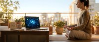 Young woman meditating on rooftop terrace at sunset with laptop displaying digital brain network, mindfulness and technology balance concept.