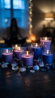 Blue scented candles burning with crystals and gemstones creating cozy atmospheric lighting for meditation, spa treatments and relaxation rituals.