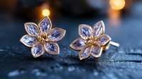 Delicate rose gold flower earrings with light purple crystal petals and golden centers on dark textured background with soft bokeh lights creating romantic ambiance.