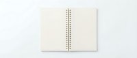 Open blank notebook with spiral binding on white background isolated for design projects and mockups.