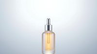 Luxury skincare serum bottle with golden oil and dropper cap on gradient background for cosmetic product photography and beauty branding materials.