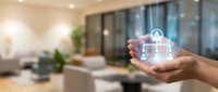 Hand holding transparent digital house hologram in modern living room showcasing smart home technology and real estate innovation concepts.