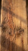 Weathered wooden plank with natural grain patterns and rustic texture for carpentry and construction projects.
