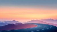 Curved mountain highway at sunset with layered purple mountains silhouettes in background, dramatic orange and pink sky creates atmospheric landscape.