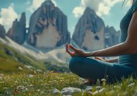 Woman meditating in lotus position on alpine meadow with dramatic Dolomites mountains in background, practicing mindfulness in nature.