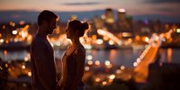 Romantic couple silhouette against city lights at sunset, intimate moment overlooking urban skyline with warm bokeh background for love concepts.