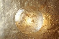 Transparent glass sphere filled with gold leaf flakes and metallic particles, creating luxurious decorative orb for interior design, cosmetics packaging, and premium product visualization.
