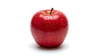 Fresh red apple with water droplets isolated on white background, suitable for food, nutrition, health and wellness design projects.